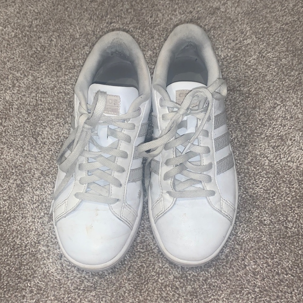 Gray and White Adidas sneakers.